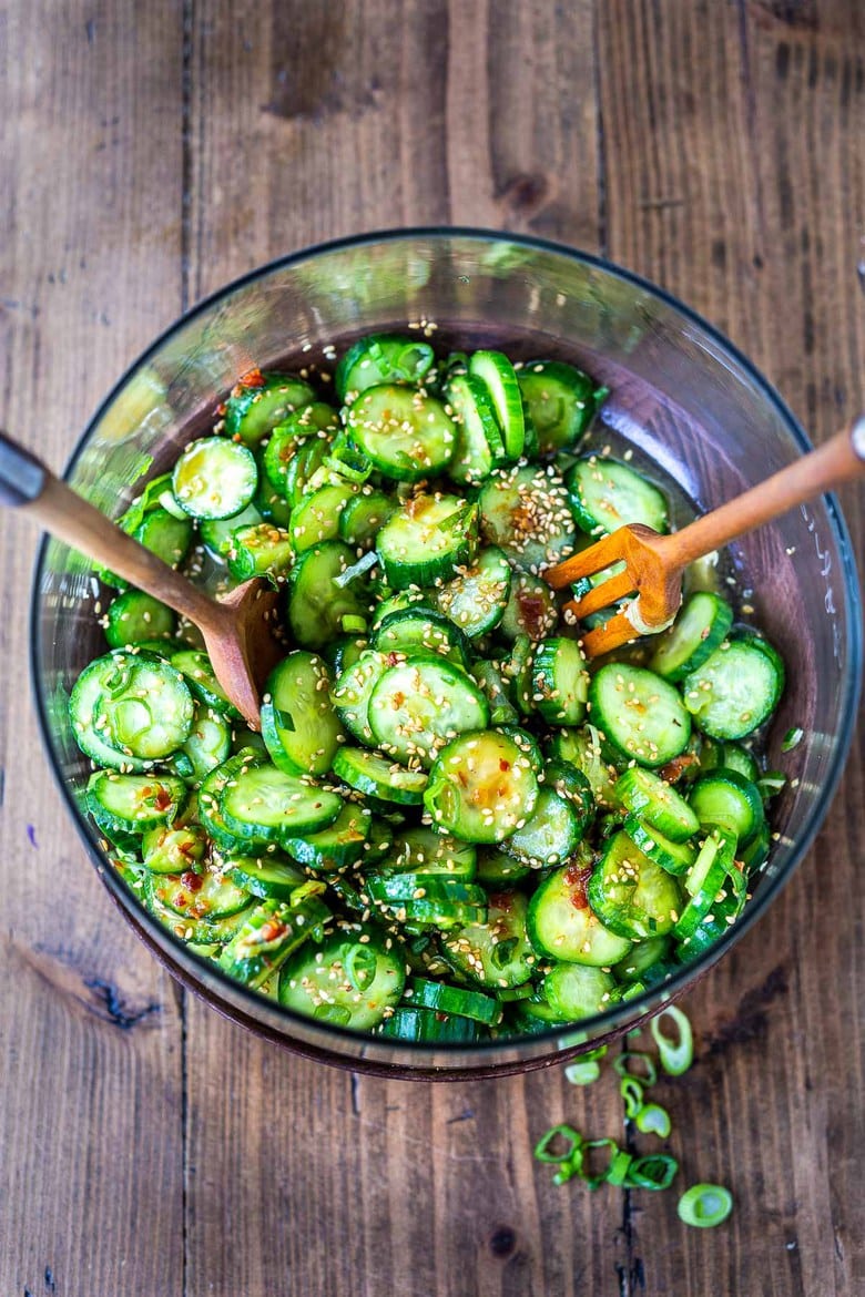 Asian Cucumber Salad made with rice vinegar, sesame, ginger, garlic and soy is cool and refreshing and pairs well with many things. It's vegan and gluten-free and is a nice addition to meals and bowls you are already making! #cucumbersalad 