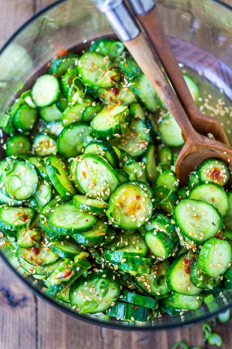Asian Cucumber Salad made with rice vinegar, sesame, ginger, garlic and soy is cool and refreshing and pairs well with many things. It's vegan and gluten-free and is a nice addition to meals and bowls you are already making! #cucumbersalad 
