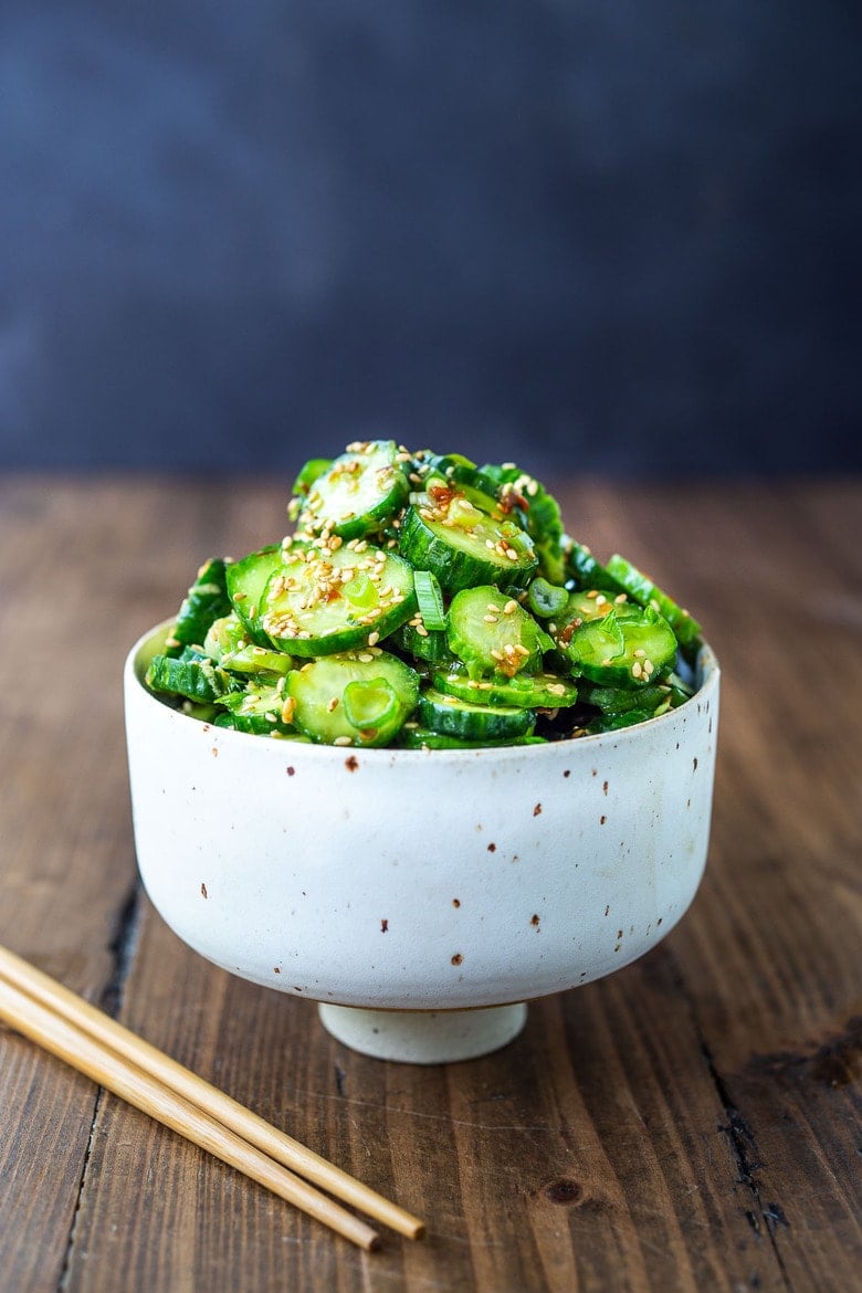 Asian Cucumber Salad made with rice vinegar, sesame, ginger, garlic and soy is cool and refreshing and pairs well with many things. It's vegan and gluten-free and is a nice addition to meals and bowls you are already making! #cucumbersalad 