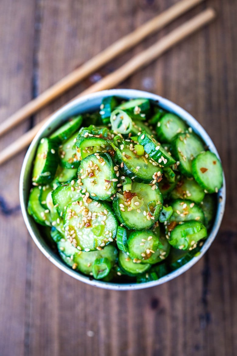 This recipe for Asian Cucumber Salad is made with rice vinegar, sesame, ginger, garlic and soy is cool and refreshing and pairs well with many things. It's vegan and gluten-free and is a nice addition to meals and bowls you are already making! #cucumbersalad 