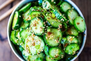 Asian Cucumber Salad made with rice vinegar, sesame, ginger, garlic and soy is cool and refreshing and pairs well with many things. It's vegan and gluten-free and is a nice addition to meals and bowls you are already making! #cucumbersalad