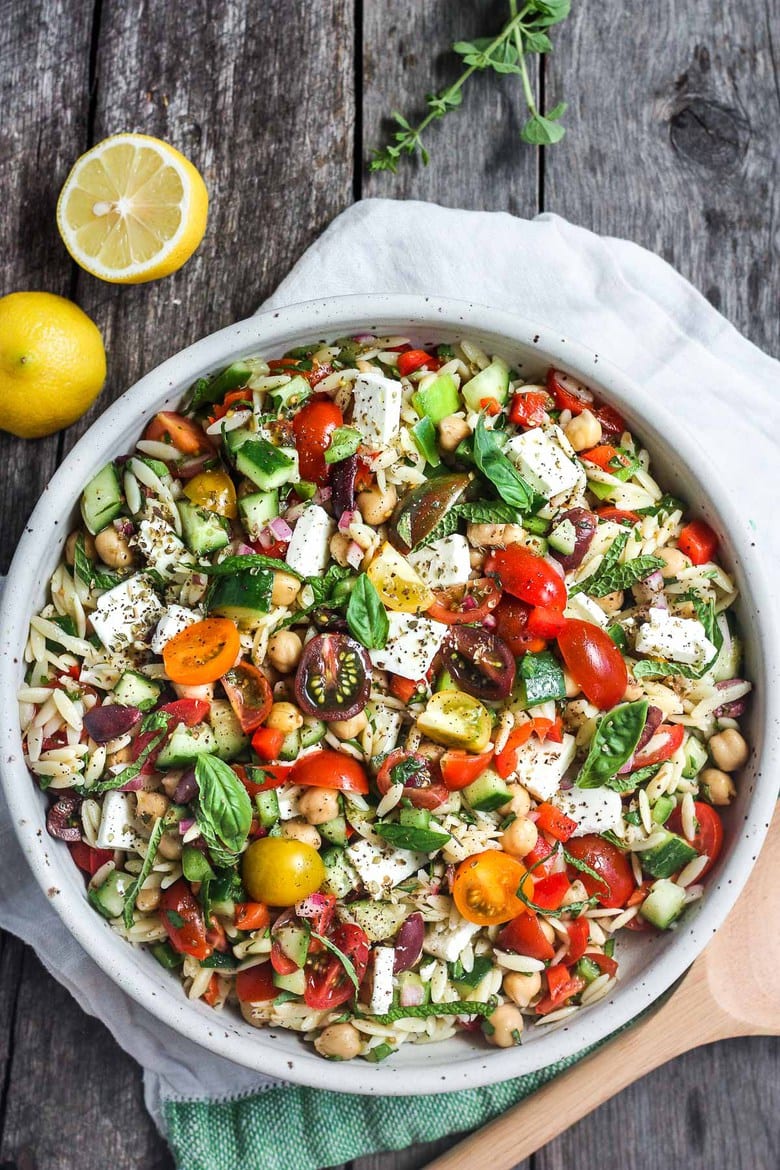 This healthy Greek Pasta Salad is the perfect make-ahead pasta salad for summertime picnics, bbqs, potlucks and easy dinners.  A hearty ratio of fresh veggies combined with tender orzo pasta, chickpeas tossed in the tastiest Greek salad dressing. 