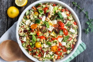 This healthy Greek Pasta Salad is the perfect make-ahead pasta salad for summertime picnics, bbqs, potlucks and easy dinners.  A hearty ratio of fresh veggies combined with tender orzo pasta, chickpeas tossed in the tastiest Greek salad dressing.