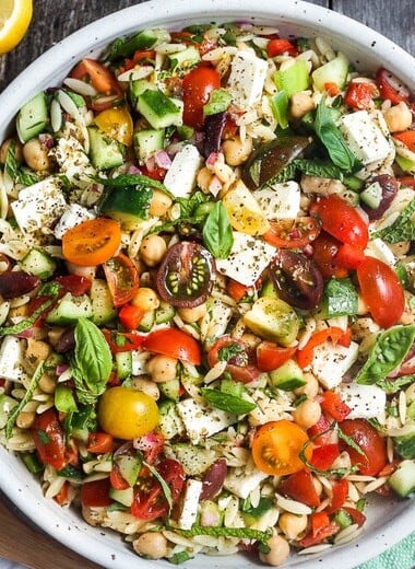 This healthy Greek Pasta Salad is the perfect make-ahead pasta salad for summertime picnics, bbqs, potlucks and easy dinners.  A hearty ratio of fresh veggies combined with tender orzo pasta, chickpeas tossed in the tastiest Greek salad dressing.