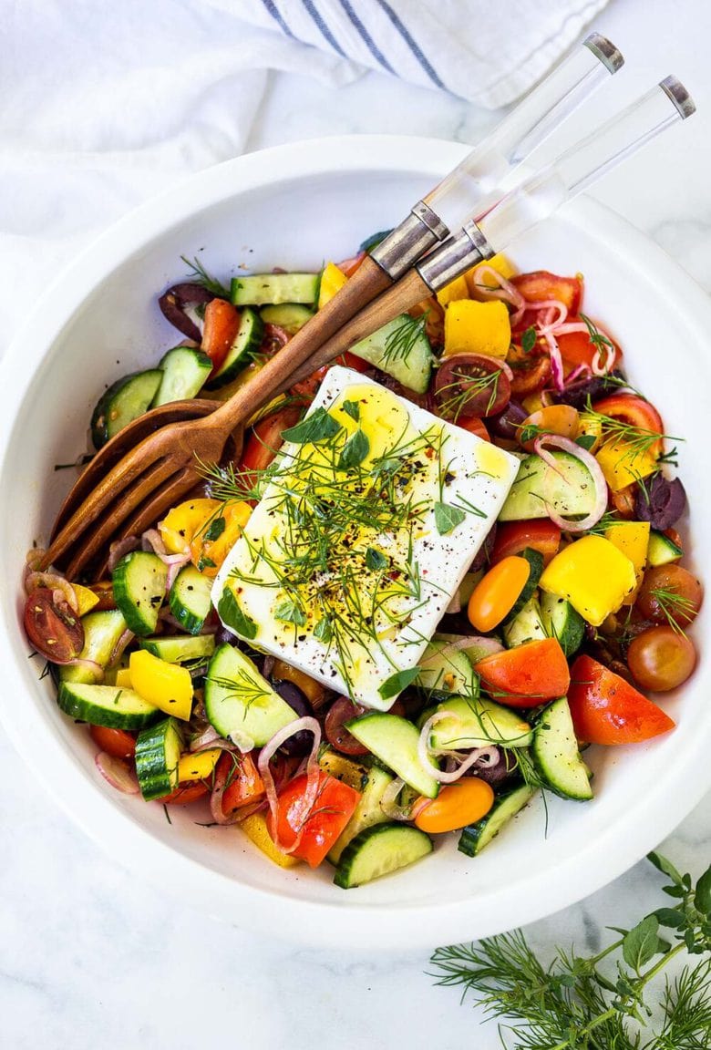 This classic Greek Salad is bursting with summertime flavor! Made with vine-ripened tomatoes, cucumbers, bell pepper, kalamata olives and sheep's milk feta, this salad highlights the best of summer produce and lets the vegetables shine! 