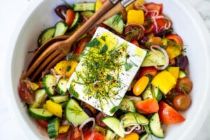 This Greek Salad is everything you want in a summer salad- refreshing, vibrant, flavorful and healthy. Simple ingredients and can be made in 20 mins! #greeksalad