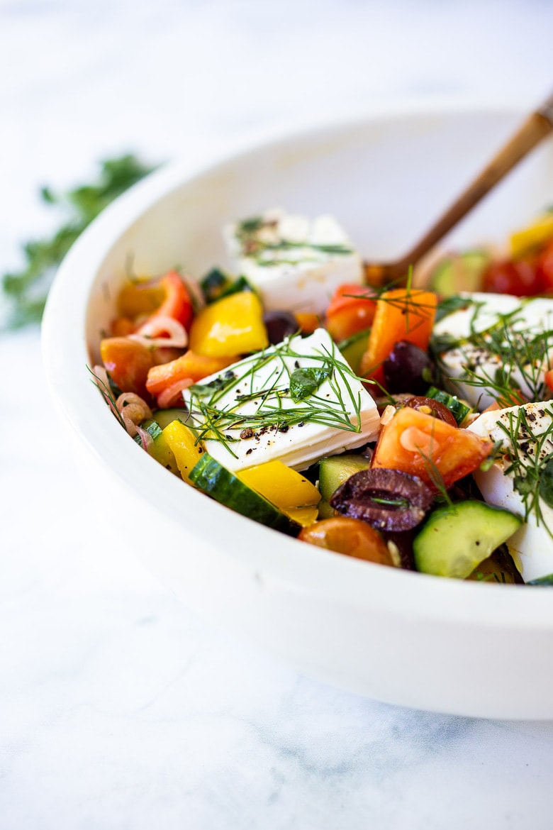 This Greek Salad is everything you want in a summer salad- refreshing, vibrant, flavorful and healthy. Simple ingredients and can be made in 20 mins! #greeksalad