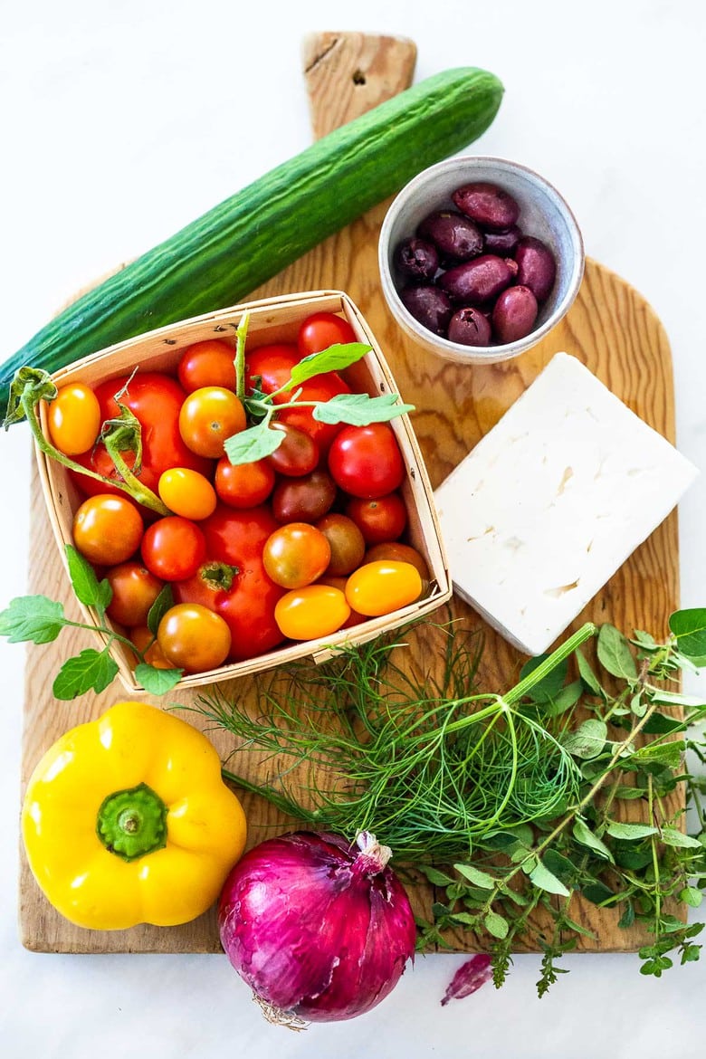 This classic Greek Salad is bursting with summertime flavor! Made with vine-ripened tomatoes, cucumbers, bell pepper, kalamata olives and sheep's milk feta, this salad highlights the best of summer produce and lets the vegetables shine! 