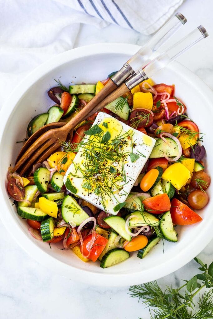 An easy potluck dish, this classic Greek Salad is bursting with summertime flavor! Made with vine-ripened tomatoes, cucumbers, bell pepper, kalamata olives and sheep's milk feta, this salad highlights the best of summer produce and lets the vegetables shine! 