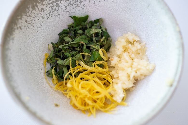 zested lemon, garlic and oregano in a bowl