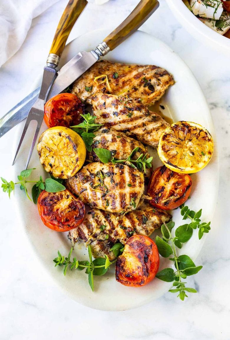 A simple, easy recipe for the juiciest, most flavorful Grilled Lemon Herb Chicken that turns out perfect every time.  Make this with skinless chicken breast or chicken thighs to pair with salads or veggies. #grilled