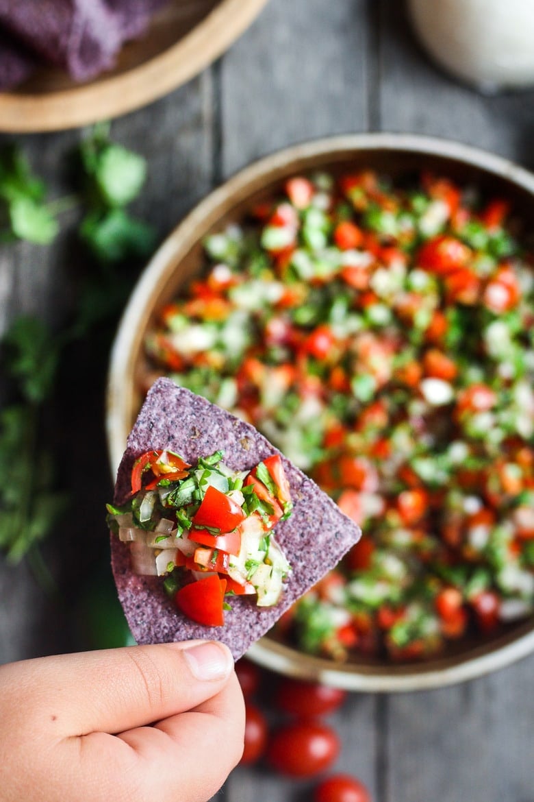 Fresh and simple Pico De Gallo is the perfect condiment for hot summer days.  Easy to make with just a few ingredients- this fresh Mexican salsa will enliven all your Mexican favorites - delicious on tacos, burritos, enchiladas and eggs, or a simple tasty appetizer served with tortilla chips! #picodegallo