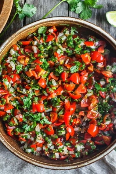 Fresh and simple Pico De Gallo is the perfect condiment for hot summer days.  Easy to make with just a few ingredients- this fresh Mexican salsa will enliven all your Mexican favorites
