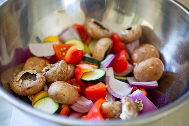 seasoning the veggies in a bowl