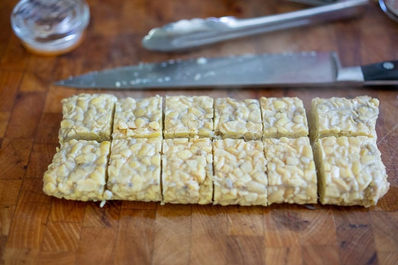 tempeh cut into cubes on a cutting board