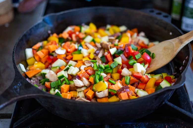 veggies sautéing in a pan