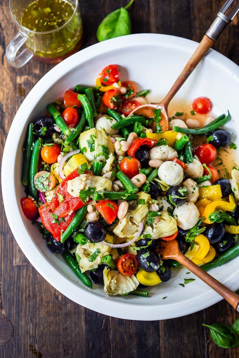 A vegetarian Antipasto Salad with made with Pantry ingredients, fresh veggies, and lots of herbs, tossed in a simple Italian dressing. Vegan and Low Carb. #antipasta #antipastasalad