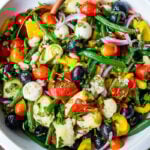 Antipasto Salad with white beans, aritchoke hearts, olives, fresh veggies, and lots of herbs, tossed in a simple Italian dressing. Vegan and Low Carb adaptable!