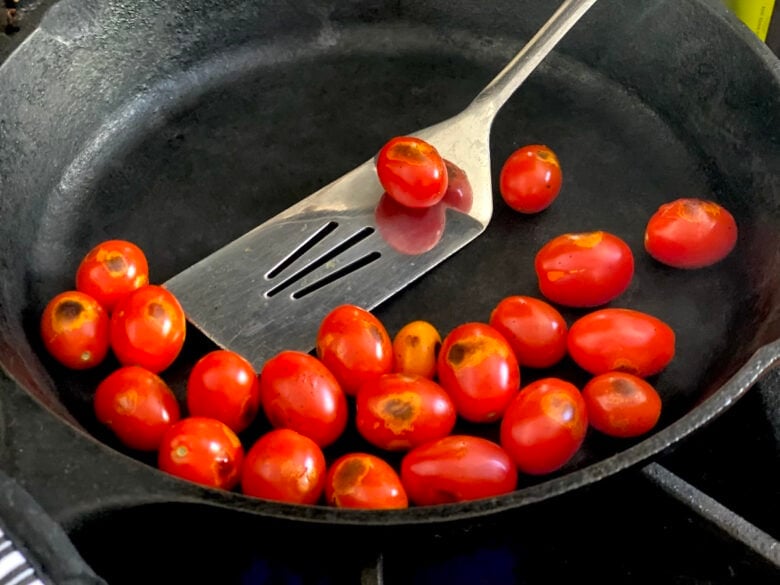 Charring the tomatoes in a pan for Tomato Vinaigrette.