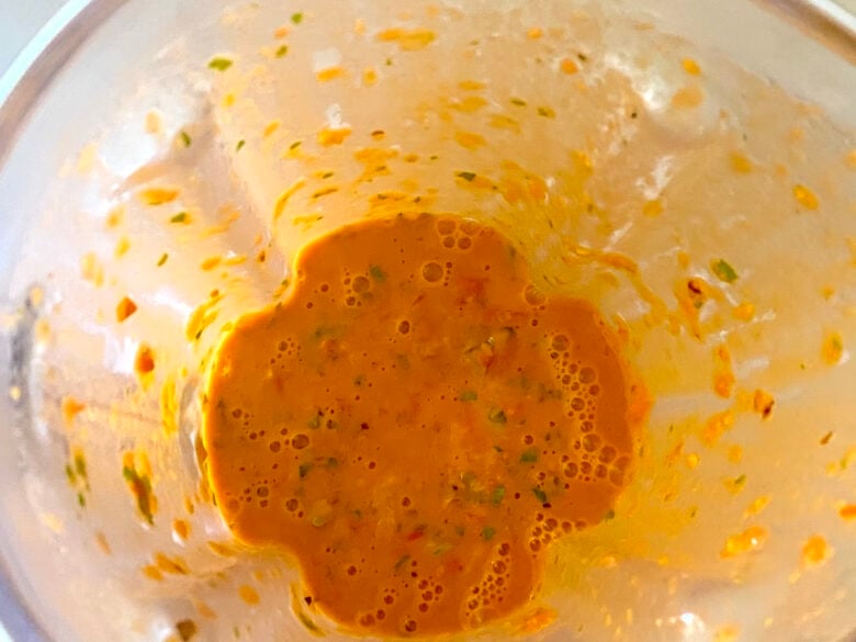 Blended tomato vinaigrette in a blender.