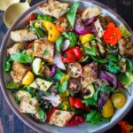Delicious Grilled Panzanella Salad with colorful sweet bell peppers, artichoke hearts, and white beans tossed in a flavorful white balsamic dressing.  Make it on the barbecue for an easy outdoor summer meal with your favorite grilled protein!  Vegan!