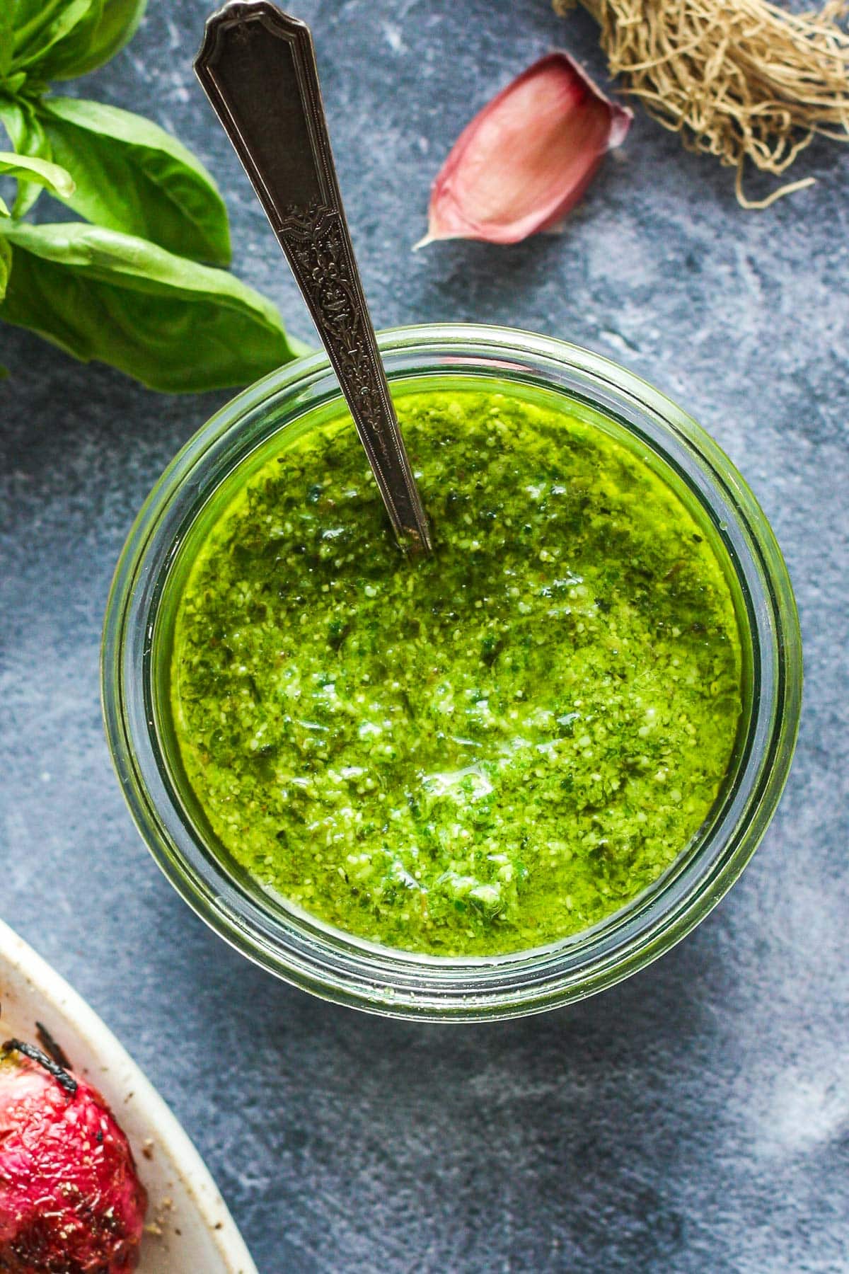 This fresh Basil Pesto recipe is brimming with bright and savory peppery basil goodness!  This version is nut-free, made with nutritious hemp seeds and a splash of lemon.