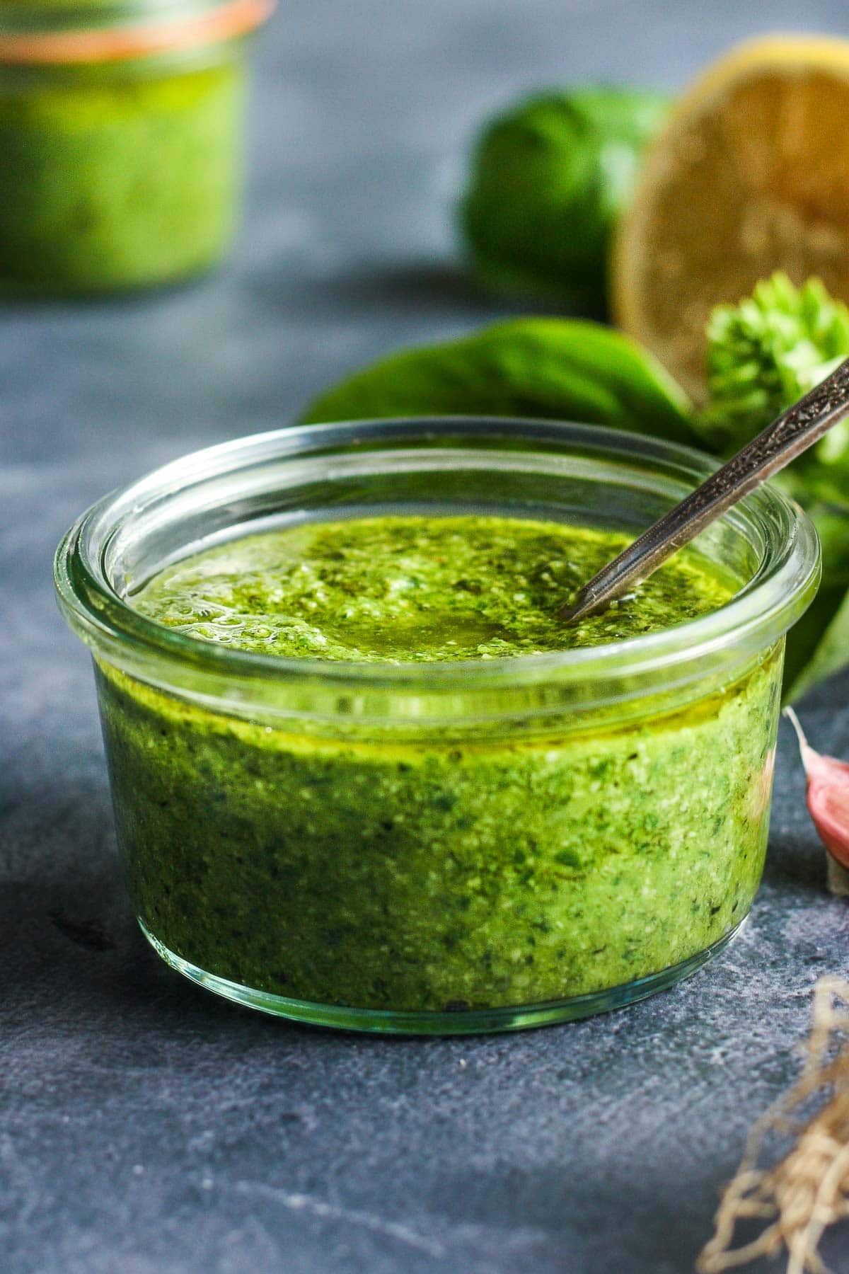 This fresh Basil Pesto recipe is brimming with bright and savory peppery basil goodness!  This version is made with nutritious hemp seeds and a splash of lemon.  A brilliant condiment that compliments so many dishes.  It freezes beautifully, it is easy to make and it is perfectly delicious!  Vegan adaptable and nut-free!