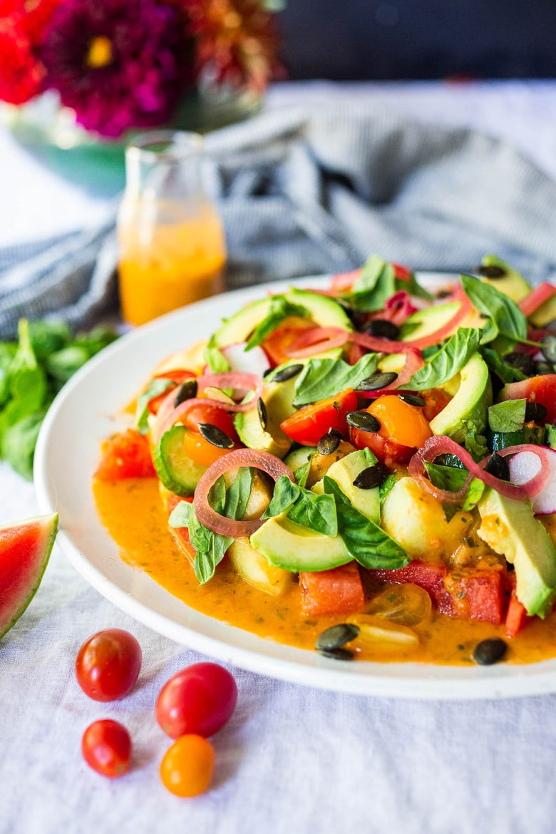 Tomato Watermelon Salad with cucumber, avocado, basil, pumpkin seeds and pickled shallots tossed in the most flavorful Tomato Vinaigrette. 