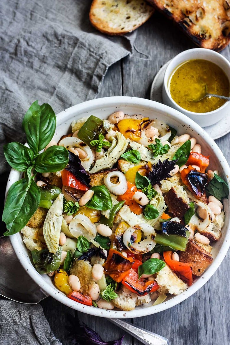 Delicious Grilled Tuscan Bread Salad with colorful sweet bell peppers, artichoke hearts and white beans tossed in a flavorful white balsamic dressing.  Be prepared, everyone at the potluck is going to want the recipe for this one! (Vegan!)