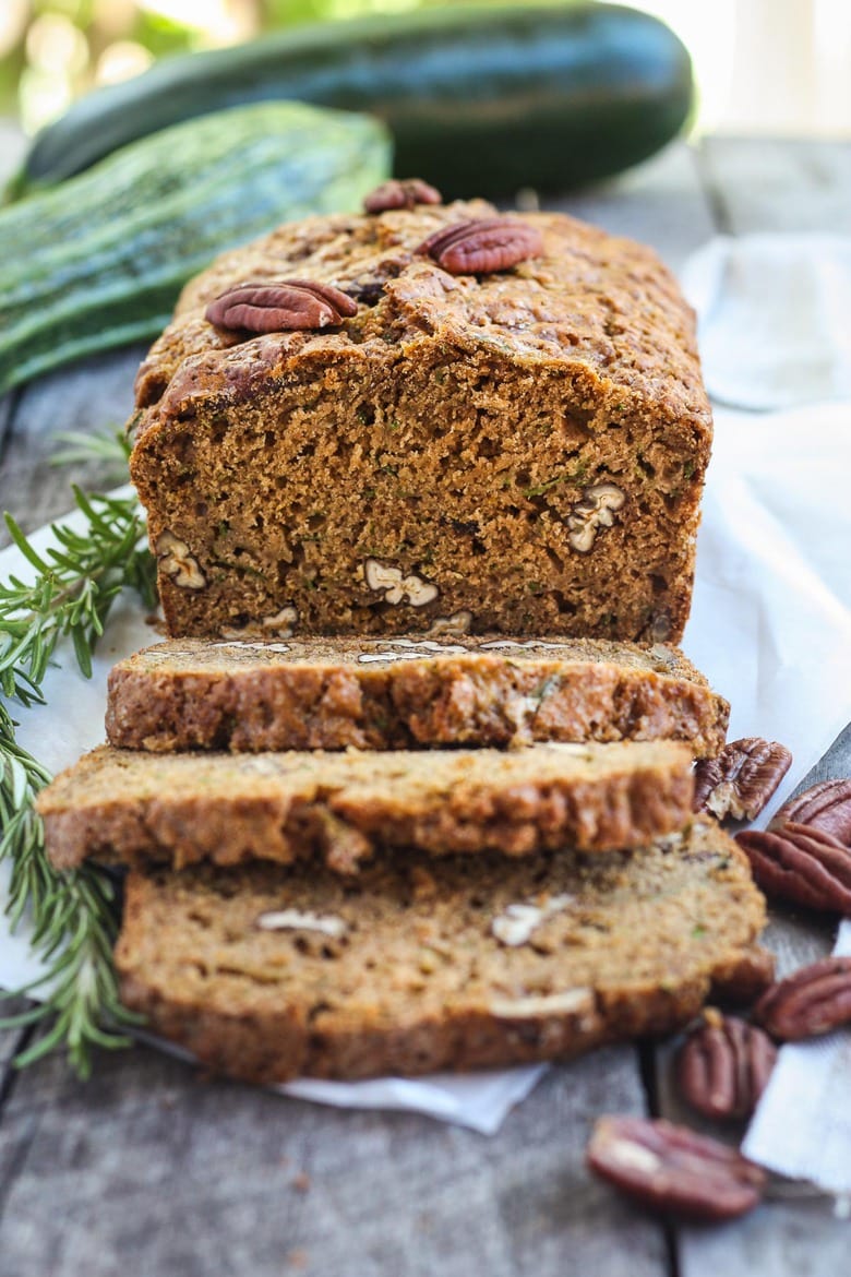 This healthy wholesome zucchini bread is tender and full of flavor.  Made with whole wheat pastry flour and coconut sugar with a touch of orange and rosemary, packing a whole pound of zucchini in one loaf!  Try this potluck recipe and watch it disappear!