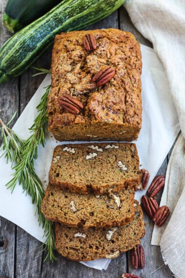 This healthy zucchini bread is tender and full of flavor.  Made with whole wheat flour and coconut sugar with a touch of orange and rosemary, packing a whole pound of zucchini in one loaf!