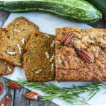 This healthy wholesome zucchini bread is tender and full of flavor.  Made with whole wheat pastry flour and coconut sugar with a touch of orange and rosemary, packing a whole pound of zucchini in one loaf!