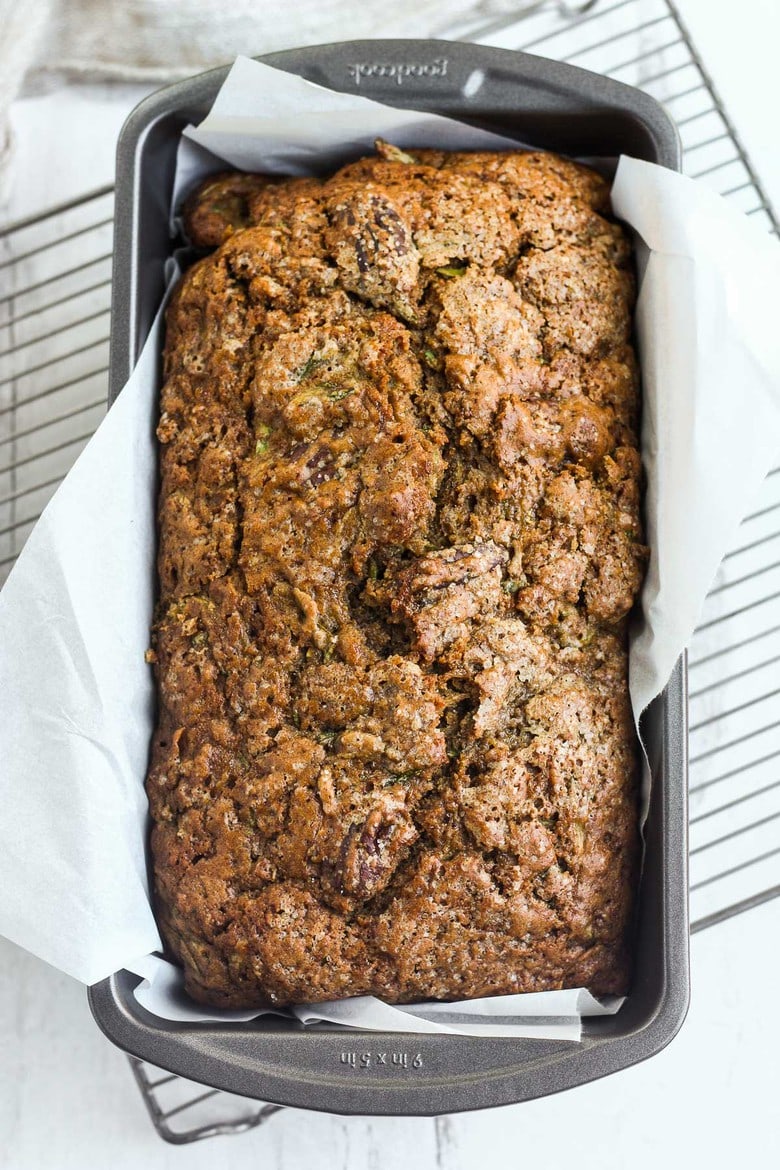 This healthy wholesome Zucchini Bread is tender and full of flavor.  Made with whole wheat pastry flour and coconut sugar with a touch of orange and rosemary, packing a whole pound of zucchini in one loaf!