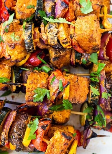 Grilled Veggie Kabobs with your choice of protein (tempeh, tofu, chicken, or shrimp) loaded up with healthy summer veggies and a flavorful harissa yogurt sauce. Vegan adaptable! 