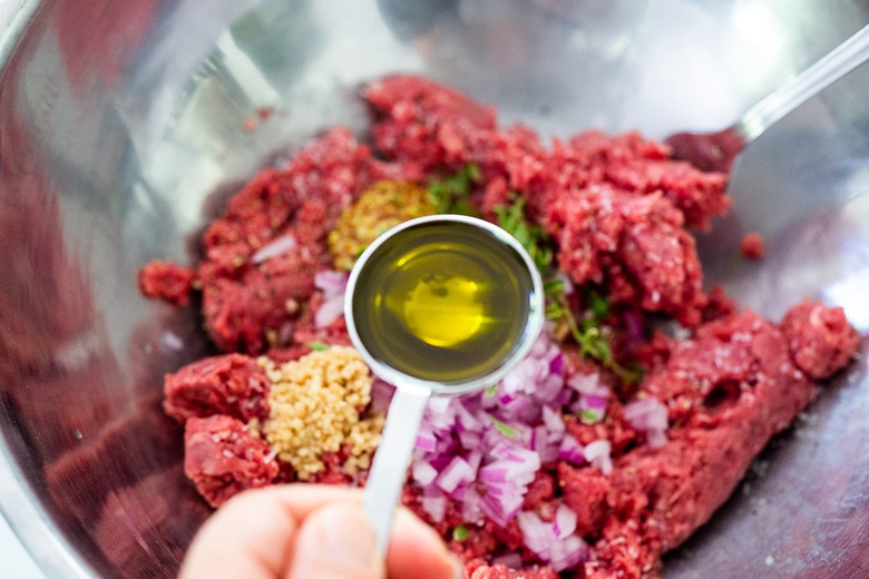 adding olive oil to the bison burger mixture