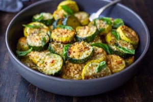 Baked Zucchini with Pecorino and Basil- a crispy flavorful zucchini side dish that is simply irresistible and pairs well with many things!