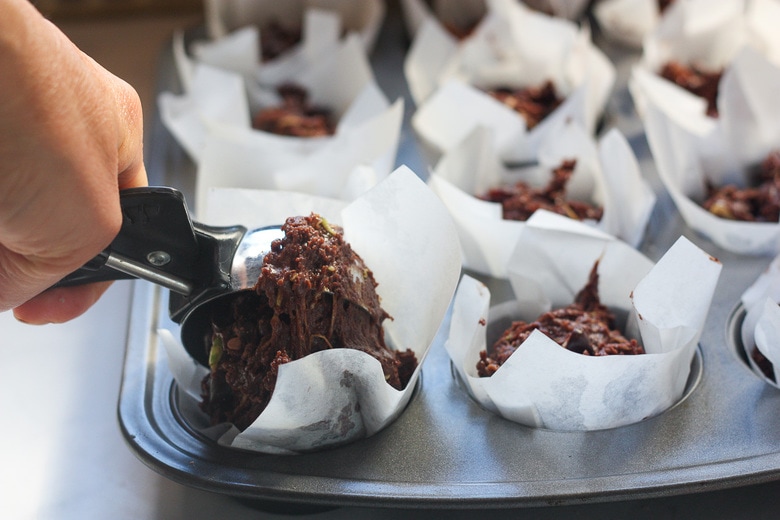 scooping batter in muffin tins