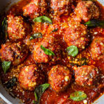 These Italian-inspired Turkey Meatballs with Sun-dried Tomato and Basil can be baked in the oven or pan-seared on the stovetop. Simmer them in your favorite marinara sauce for a few minutes, then serve over pasta or with veggies, for a quick healthy weeknight meal. #bakedmeatballs #turkeymeatballs #italianmeatballs