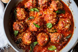 These Italian-inspired Turkey Meatballs with Sun-dried Tomato and Basil can be baked in the oven or pan-seared on the stovetop. Simmer them in your favorite marinara sauce for a few minutes, then serve over pasta or with veggies, for a quick healthy weeknight meal. #bakedmeatballs #turkeymeatballs #italianmeatballs