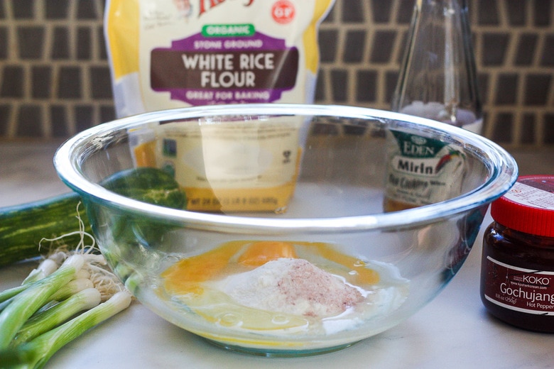 mixing eggs and rice flour to make the scallion pancake batter