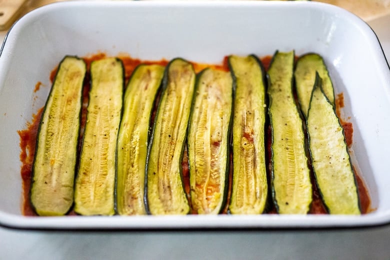 first layer of zucchini over the sauce. 