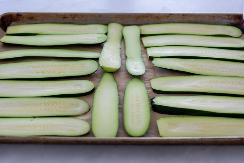 zucchini slices on a sheet pan, ready to roast or grill 