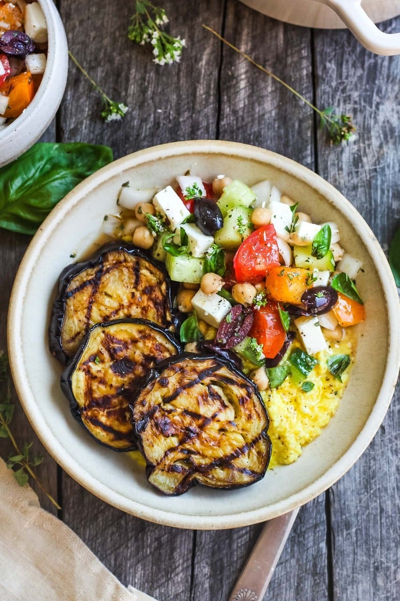 Perfectly tender smoky Grilled Eggplant with fresh Greek relish and creamy polenta.  An easy and healthy meatless dinner.  Vegan adaptable and gluten-free.