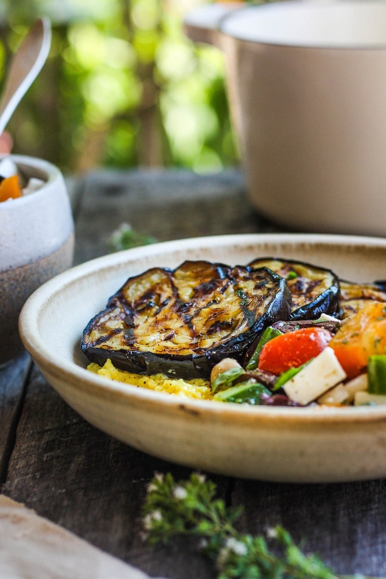 Perfectly tender smoky Grilled Eggplant with fresh Greek relish and creamy polenta.  An easy and healthy meatless dinner.  Vegan adaptable and gluten-free.