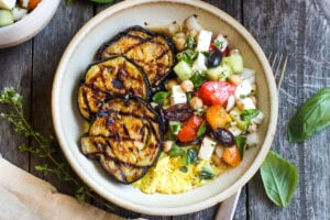 Perfectly tender smoky Grilled Eggplant with fresh Greek relish and creamy polenta.  An easy and healthy meatless dinner.  Vegan adaptable and gluten-free.