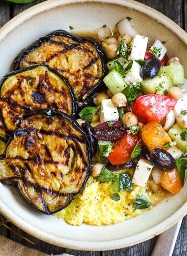 Perfectly tender smoky Grilled Eggplant with fresh Greek relish and creamy polenta.  An easy and healthy meatless dinner.  Vegan adaptable and gluten-free.