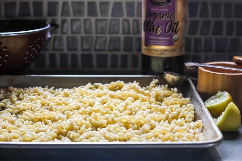 pasta cooling on a sheet pan