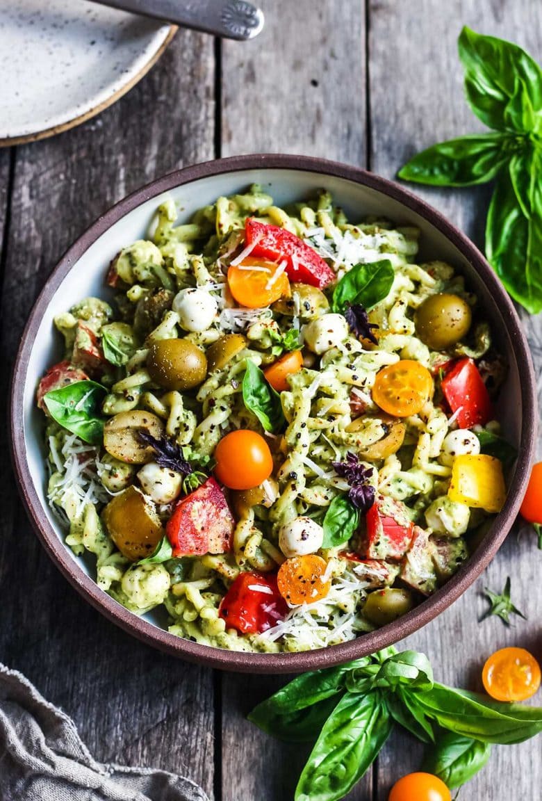 Pesto Pasta Salad w/ cherry tomatoes, baby mozzarella, olives & fresh basil tossed in a Creamy Pesto Dressing. Vegan, gluten-free adaptable.