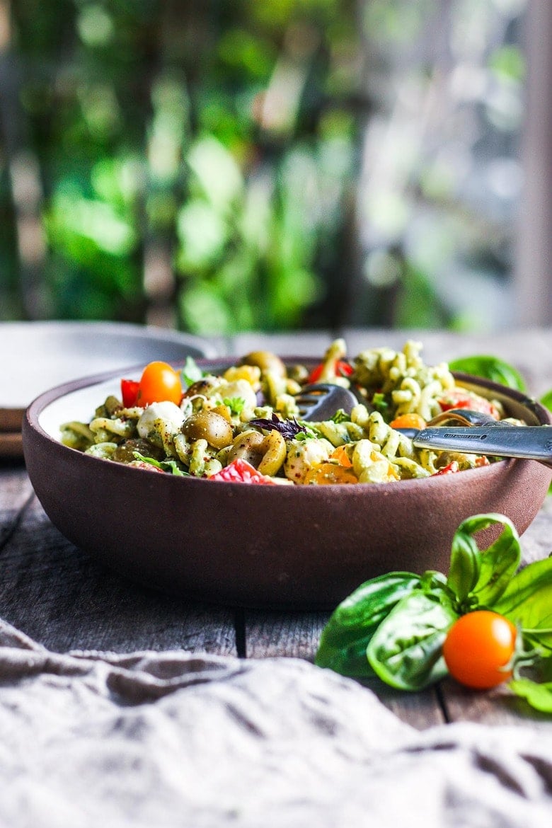 This Creamy Pesto Pasta Salad tastes like summer.  Perfect for a light dinner on its own, or serve as a side dish with grilled protein and definitely picnic-worthy!  It is simple to make, vegan, and gluten-free adaptable.