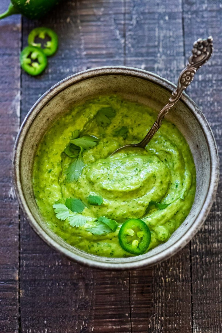  avocado sauce in a bowl with a spoon. 